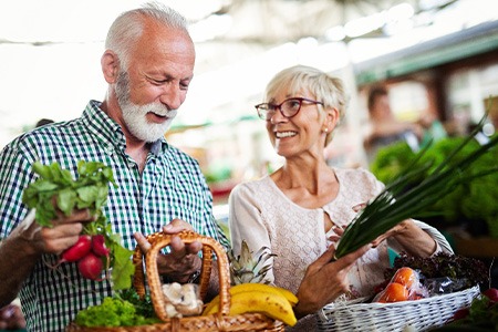 Senior couple smiling while shopping