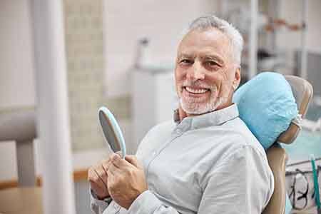 man smiling after getting dental implants 