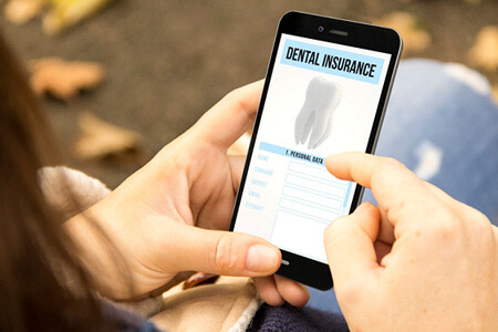 patient looking at dental insurance form on phone