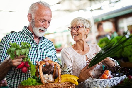 An older couple buying fresh foods