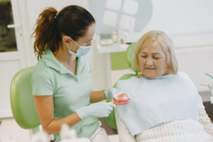 Older woman at dentist for denture care