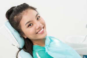 Dental patient smiling while waiting in dental chair